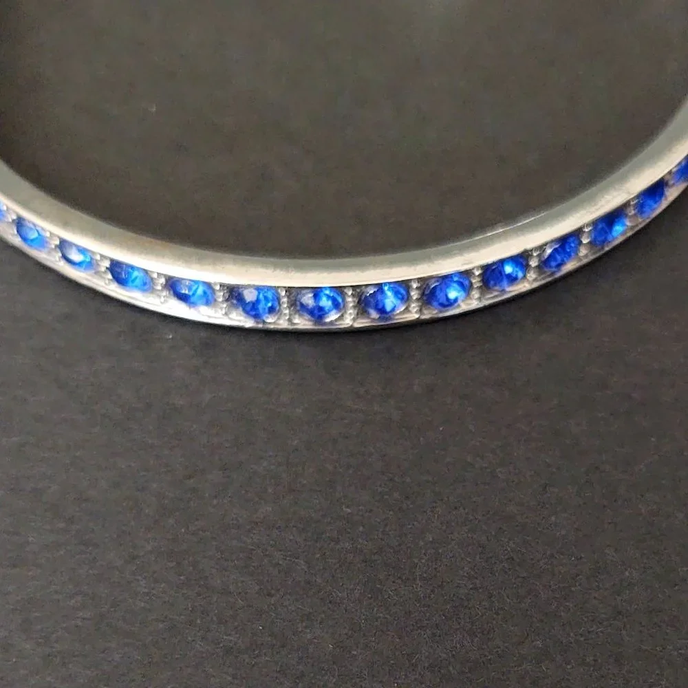 Silver bangle with inlaid blue glass beads